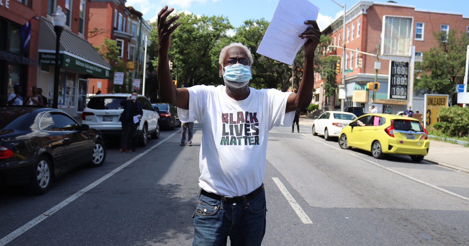 Man wearing black lives matter t-shirt walking down a street