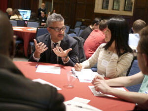 John Gamba talking at a table of people