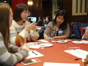 Students gather at a table to share ideas