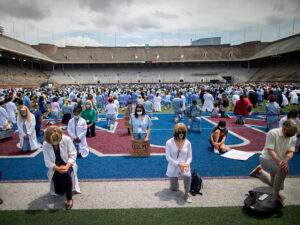 people kneeling on field in protest