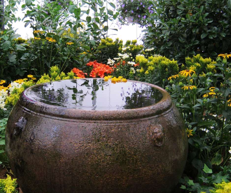 Copper vessel holding water in flower garden