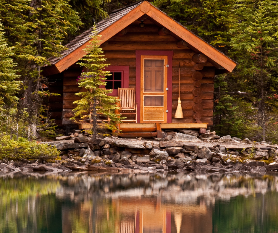 Log cabin on pond with reflection in water
