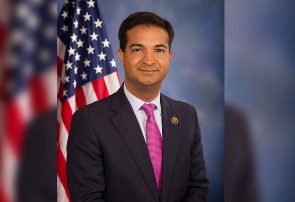 Headshot of Former Congressman Carlos Curbelo with United States Flag in the background