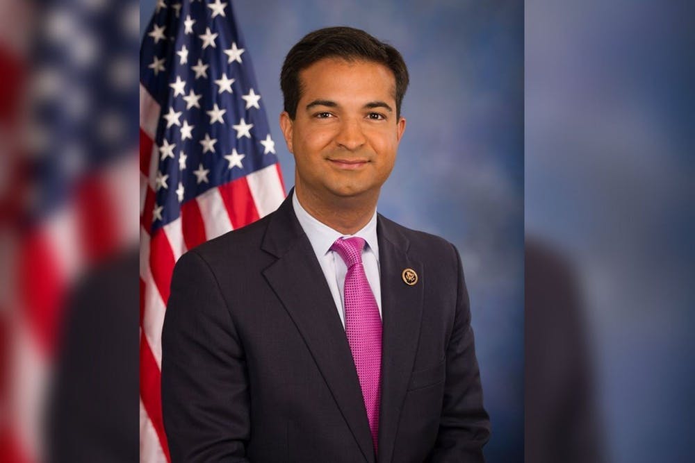 Headshot of Former Congressman Carlos Curbelo with United States Flag in the background