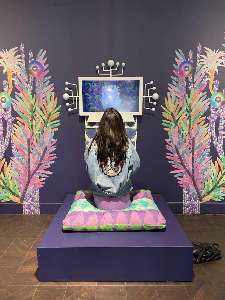 Student facing a monitor in gallery installation at Rowan University