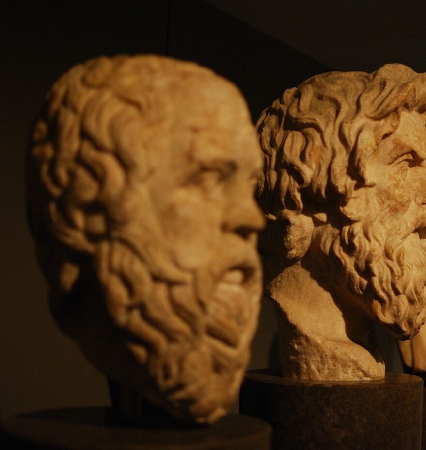 This is a photo of four orange busts with a shadow overcast on them. They are placed in descending order.