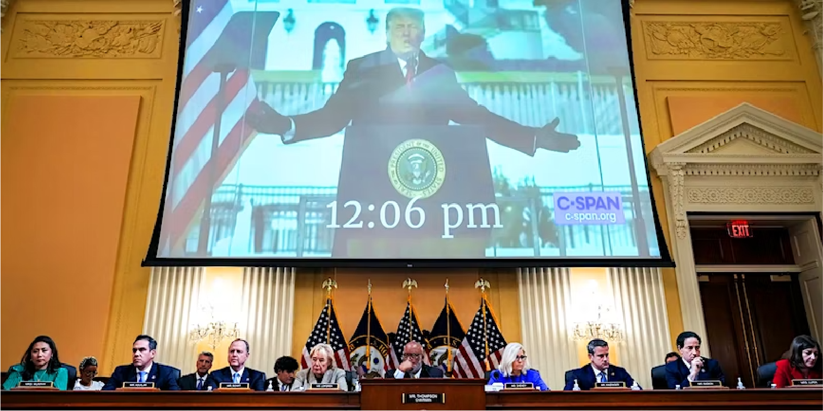 image of congress with trump on screen in background