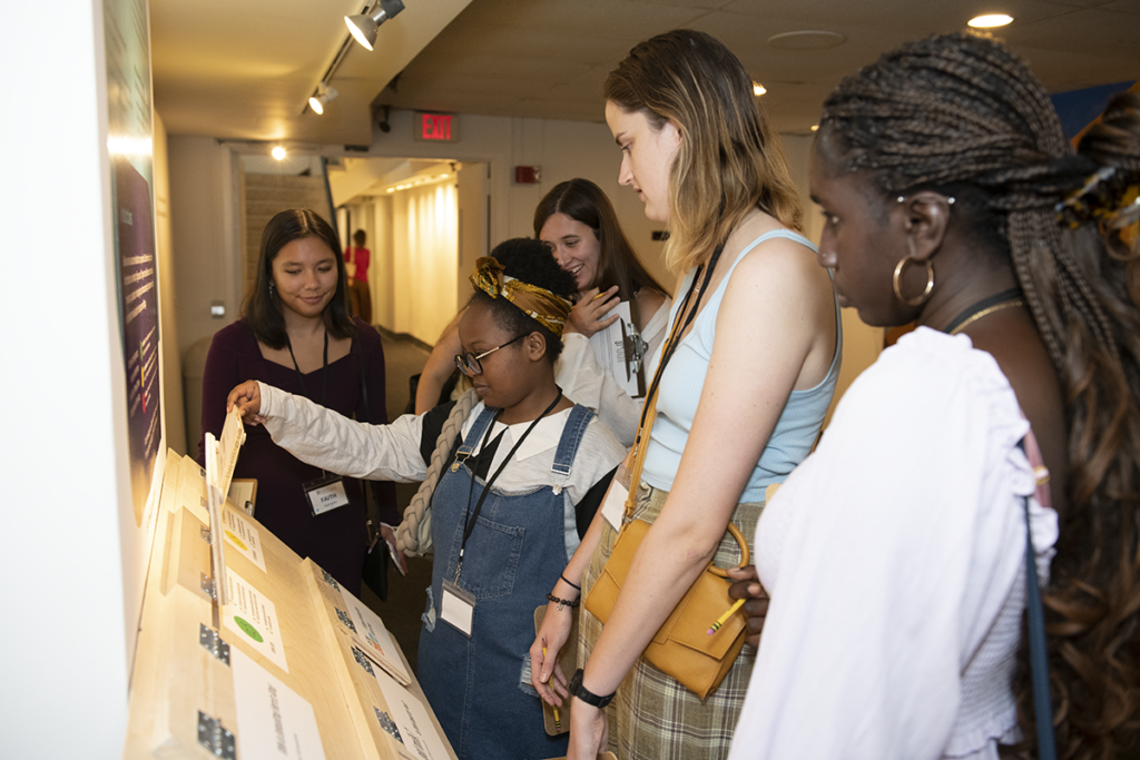 students interacting with truth exhibit
