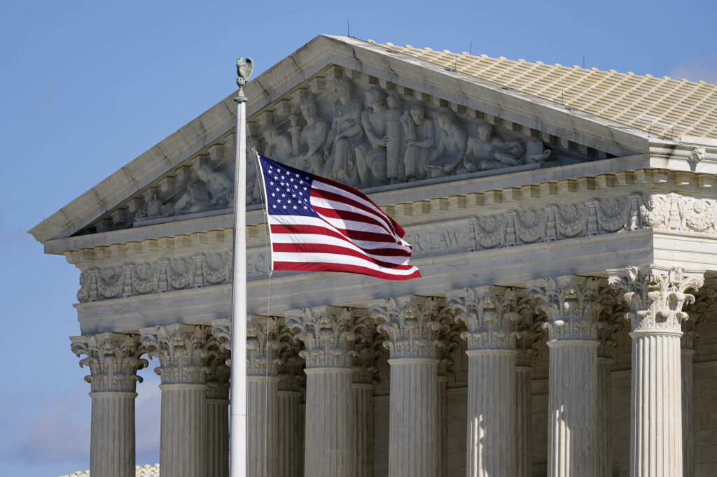 An American flag waves in front of the Supreme Court building on Capitol Hill in Washington, on Nov. 2, 2020. The Supreme Court heard oral arguments in two cases that could decide the future of affirmative action in college admissions on Monday, Oct. 31, 2022, in Washington, D.C. (Image: AP Photo/Patrick Semansky, File)