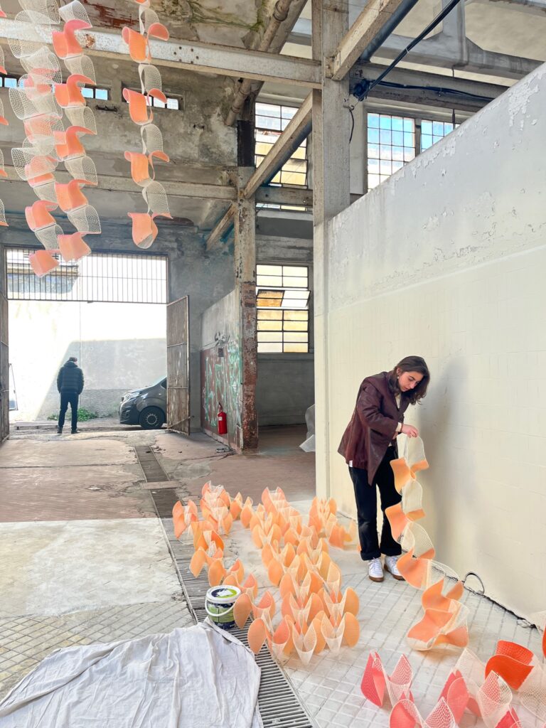 People in warehouse space working with colorful objects