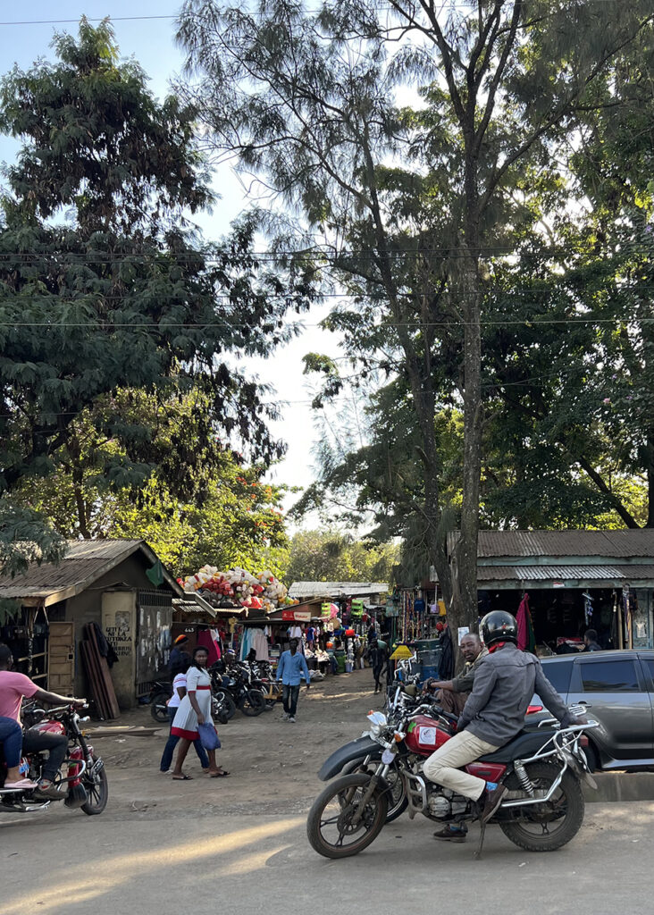 busy street with cars and motorcyclists