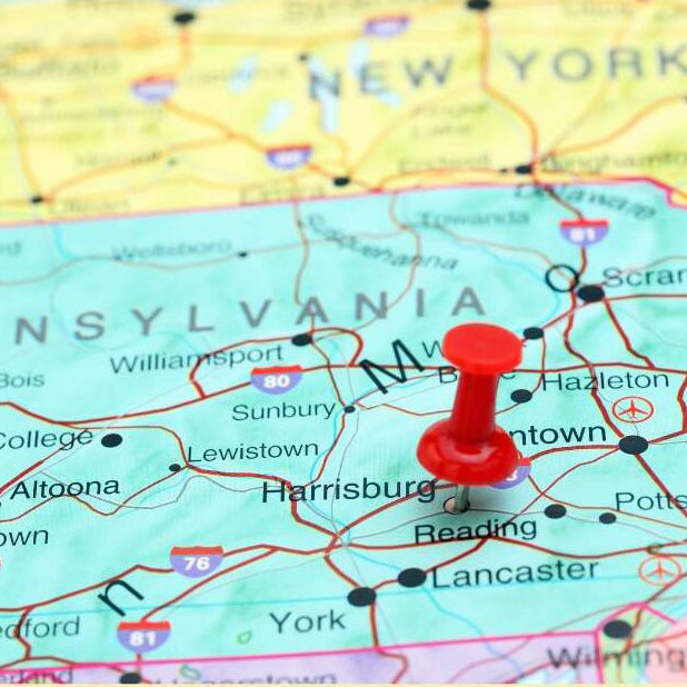 Map of Pennsylvania and surrounding states with red pushpin through Harrisburg.