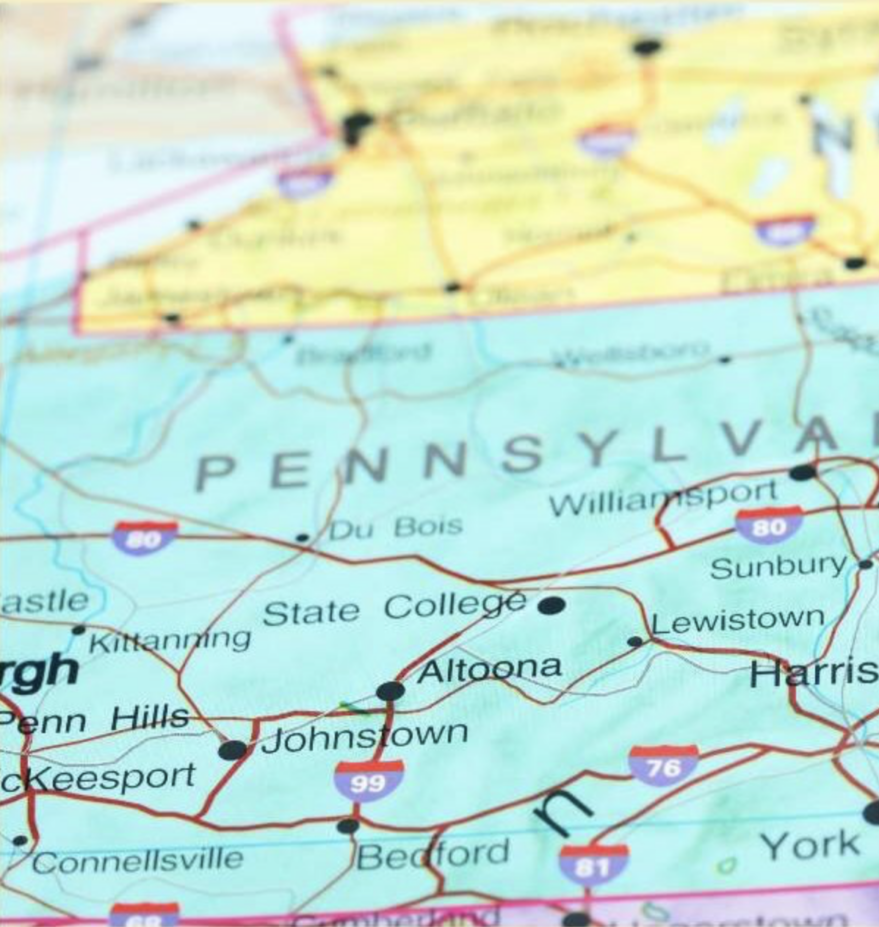 map of Pennsylvania in light green with New York above in yellow and Delaware in pink below. A red push pin appears next to Philadelphia.