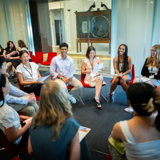 Students seated in a circle engaging in conversation