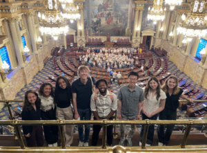 Political Empathy Lab research team in the House of Representatives in Harrisburg smiling for a group photo.