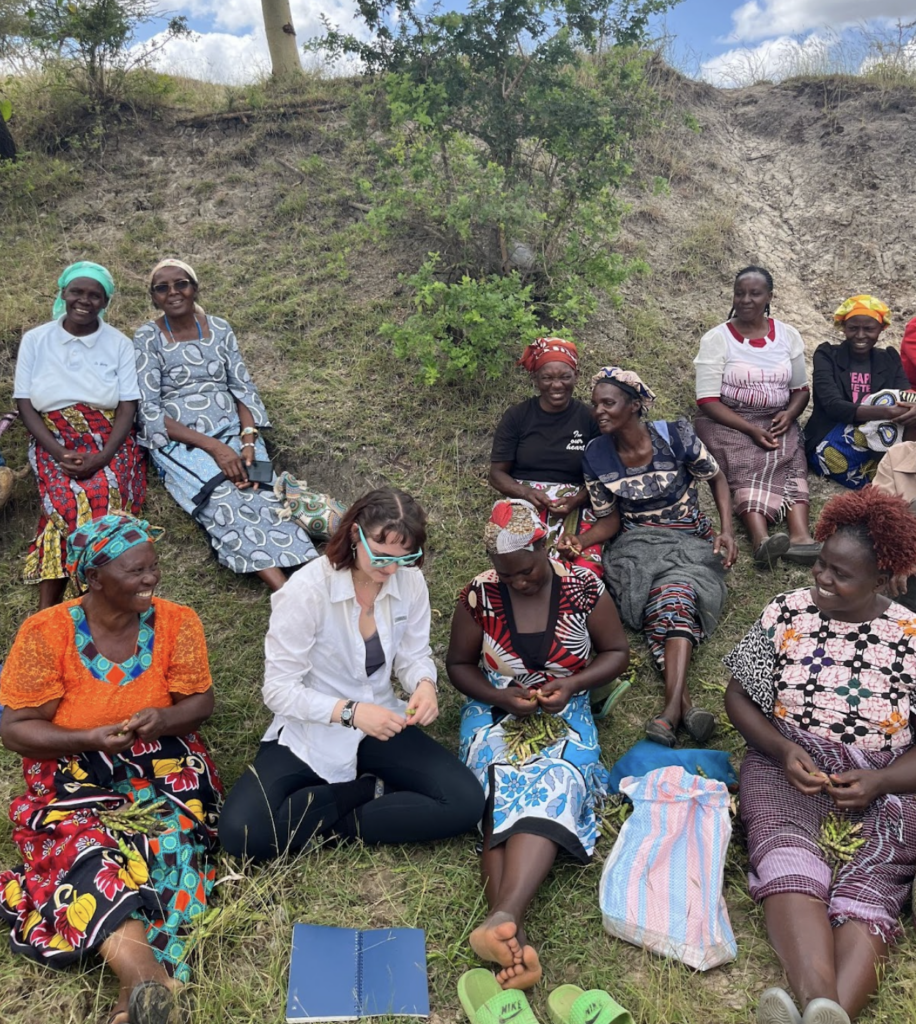 women gathered seated on a hill in Kenya