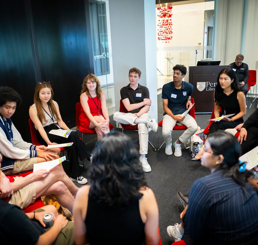 Students at the spring 2024 Capstone Dialogue & Symposium sitting together in a circle engaged in dialogue.