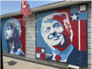 Mural showing a picture of Jesus on the left and Donald Trump on the right painted in red, white and blue.