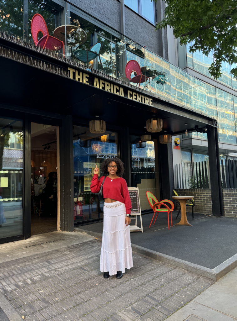 student in front of the Africa Centre