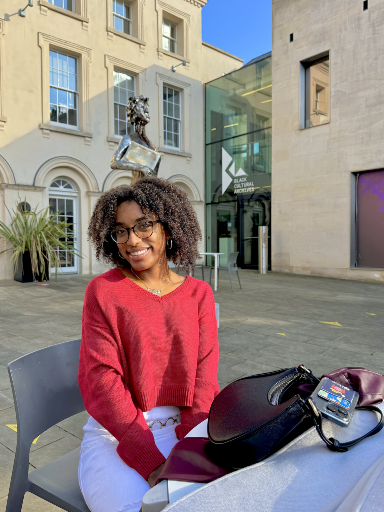 student in front of black cultural archives in London