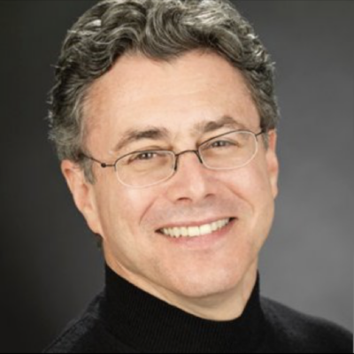 headshot for faculty member. Man with light skin, salt and pepper hair with glasses, wearing a black turtleneck shirt