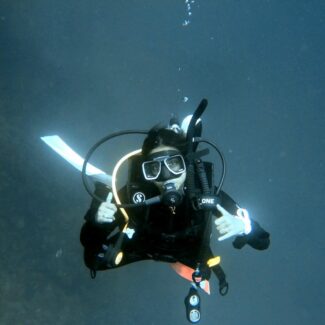author of article scuba diving and looking at the camera