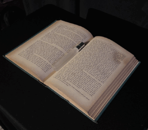 open book sitting against a black background