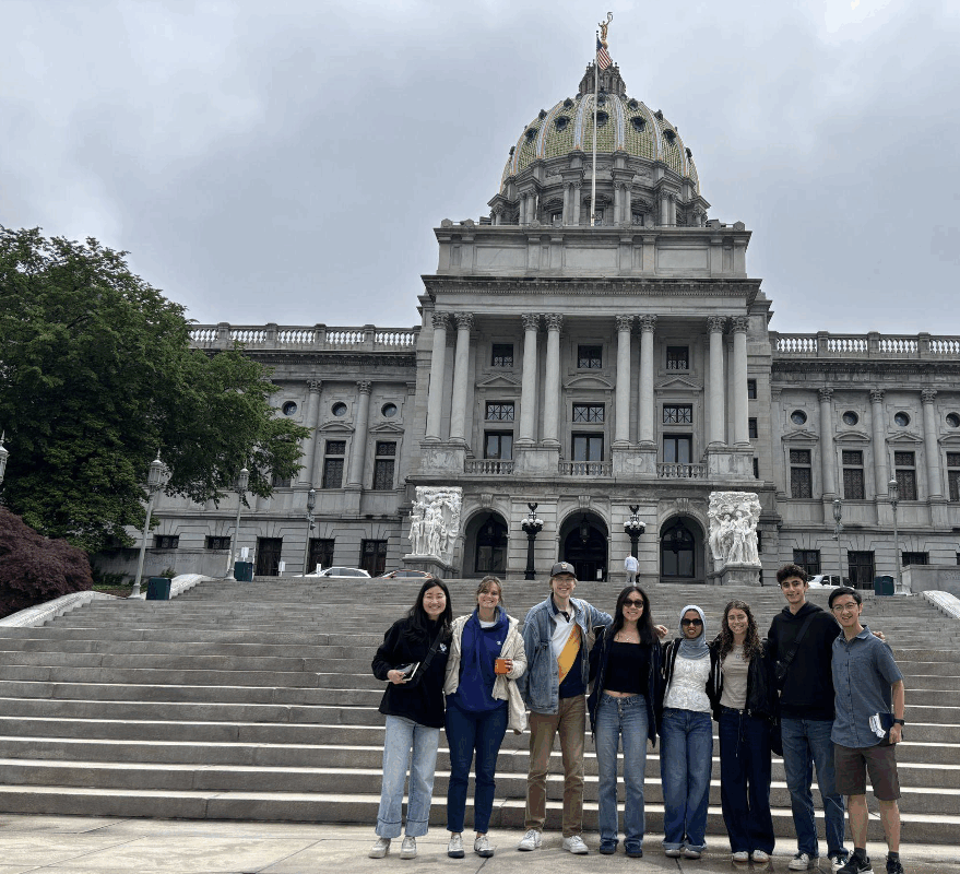 Political Empathy Lab Phase II research team in group photo standing on the steps of the state Capitol building in Harrisburg