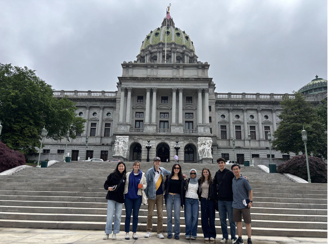 Political Empathy Lab Phase II research team in group photo standing on the steps of the state Capitol building in Harrisburg